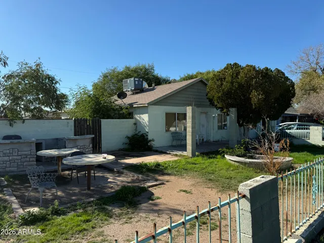a view of a house with backyard and sitting area