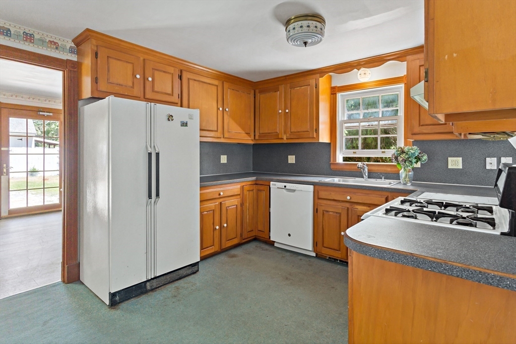 426 Old Post Road Barnstable, MA 02635 - Photo 3 of 27 a kitchen with a refrigerator a sink and cabinets