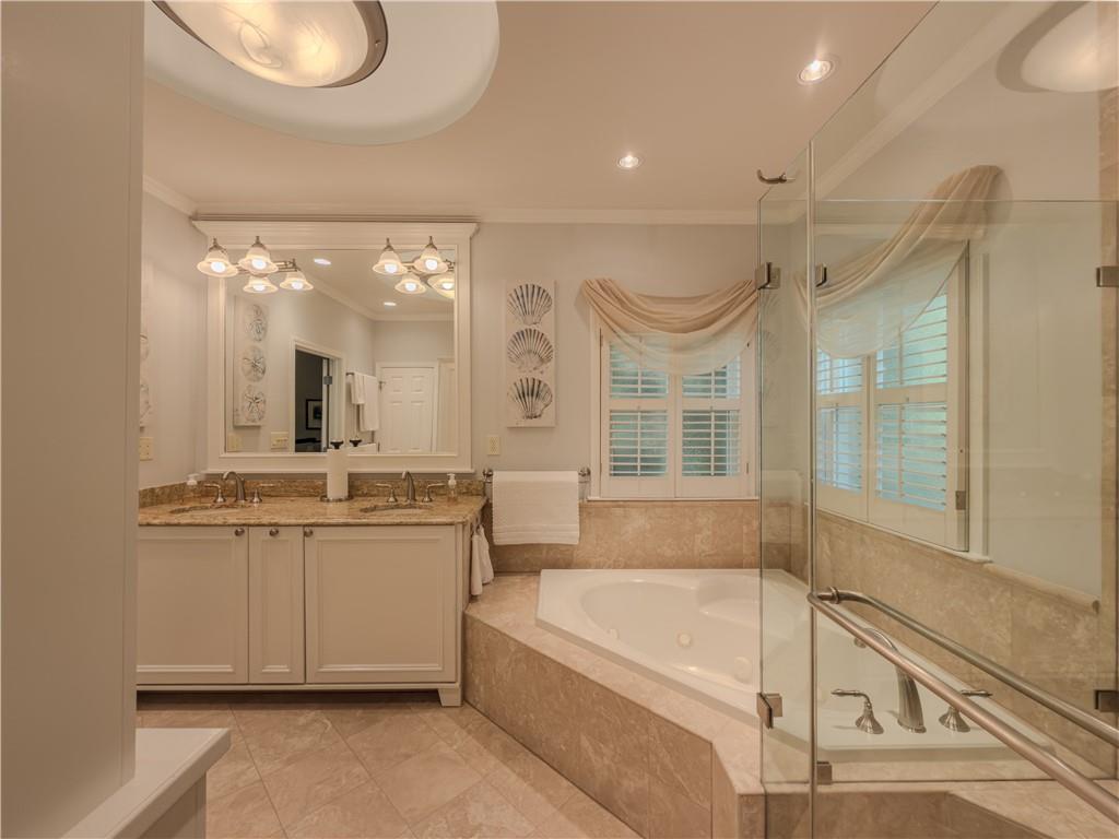 4284 Cedar Bluff Way Southwest Lilburn, GA 30047 - Photo 17 of 62 a bathroom with a tub a double vanity sink and a mirror