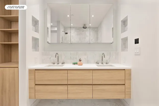 a room with a sink a toilet and mirror