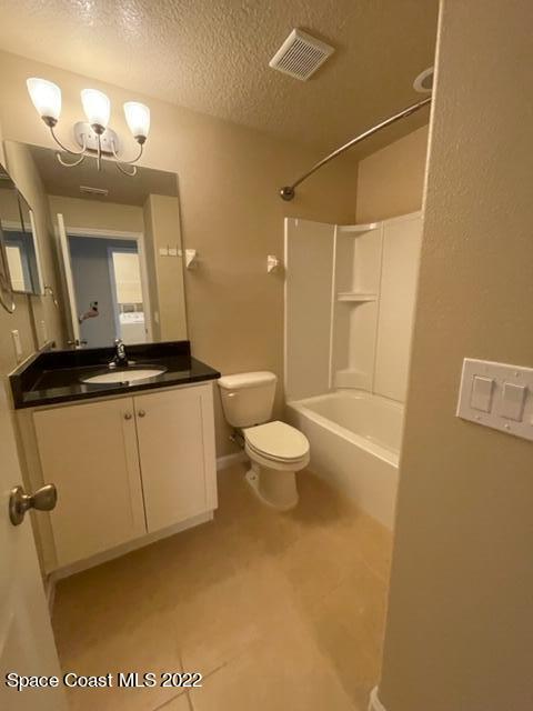 1420 Lara Circle, Unit 105 Rockledge, FL 32955 - Photo 15 of 20 a bathroom with a toilet a sink and mirror