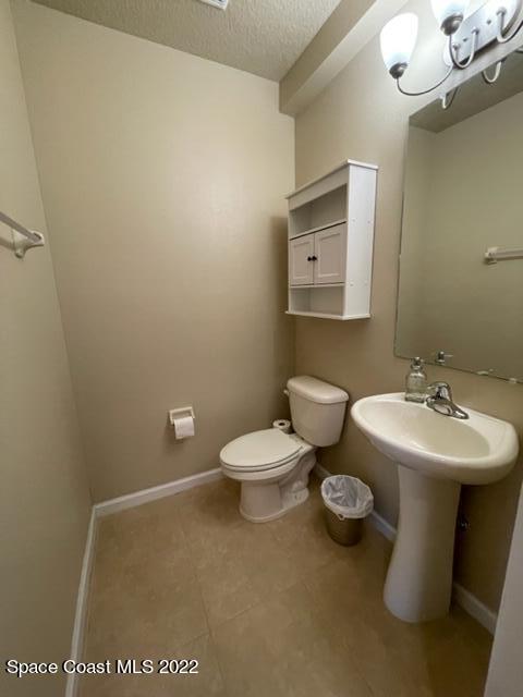 1420 Lara Circle, Unit 105 Rockledge, FL 32955 - Photo 6 of 20 a bathroom with a toilet sink and mirror