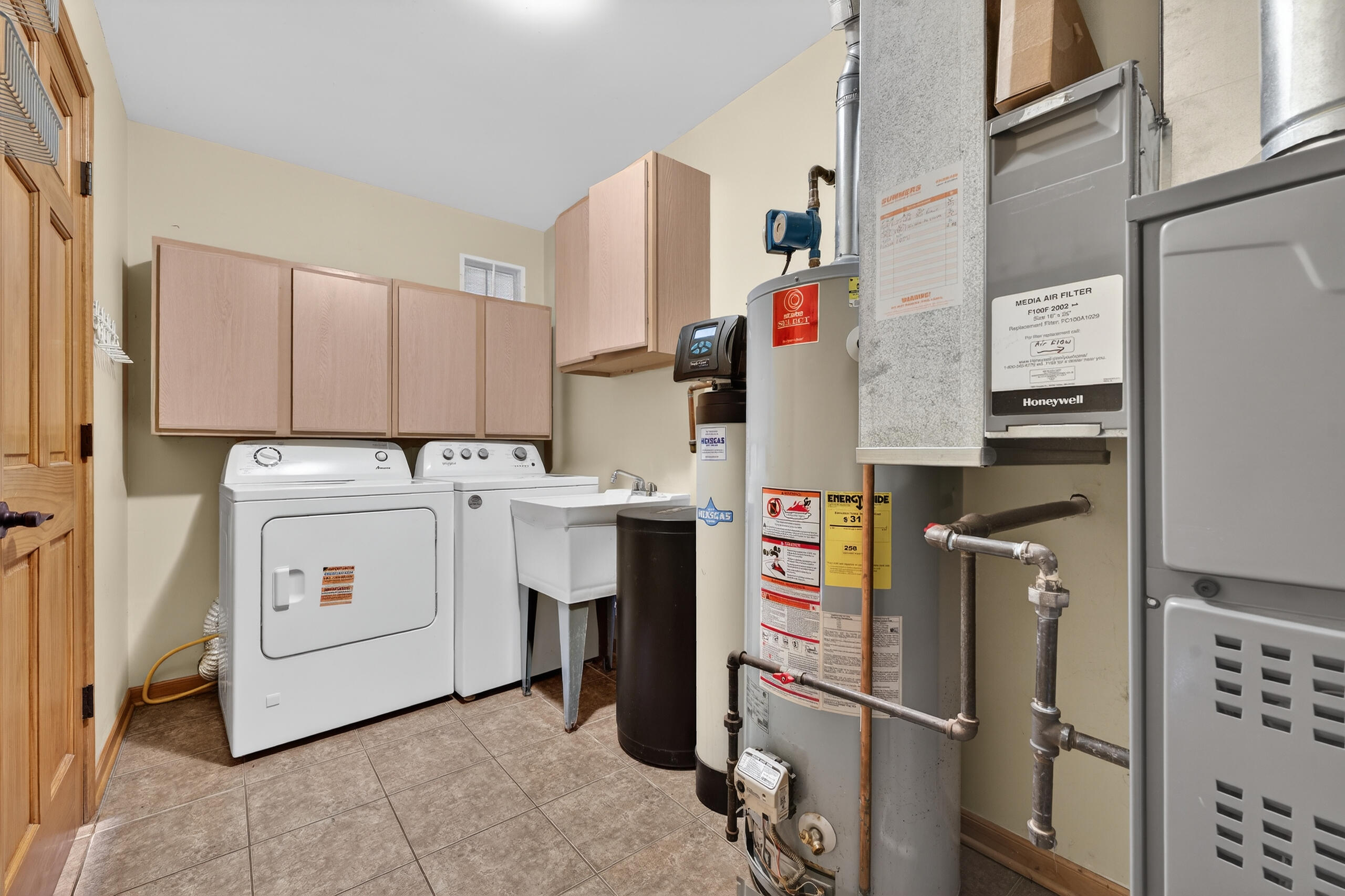 5005 West 152nd Court Crown Point, IN 46307 - Photo 17 of 22 a utility room with dryer washer and a view of living room