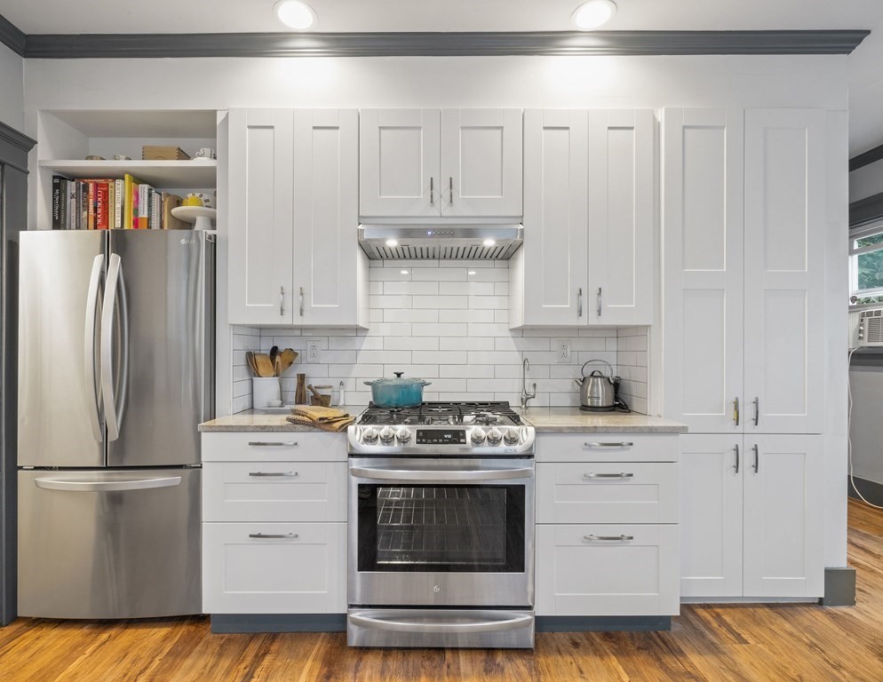 18 Alpha Road Boston, MA 02124 - Photo 12 of 42 a kitchen with a stove cabinets and stainless steel appliances