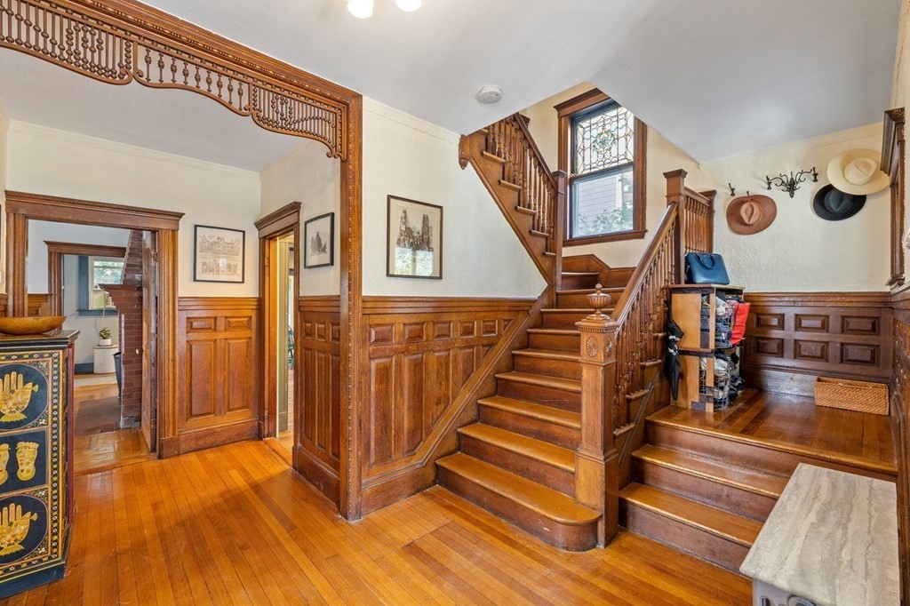 18 Alpha Road Boston, MA 02124 - Photo 17 of 42 a view of a hallway with wooden floor and stairs