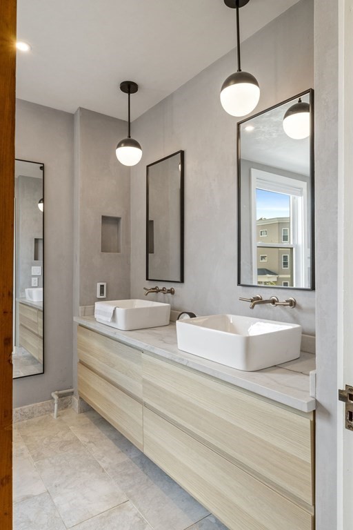 18 Alpha Road Boston, MA 02124 - Photo 19 of 42 a bathroom with double vanity sinks and a mirror