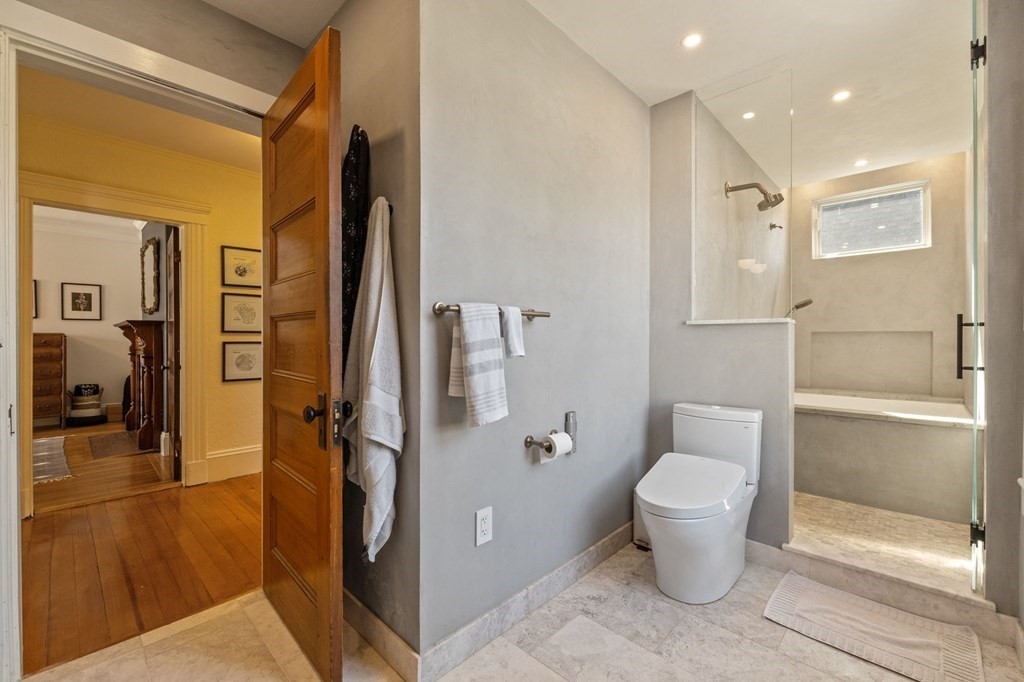 18 Alpha Road Boston, MA 02124 - Photo 20 of 42 a spacious bathroom with a granite countertop sink toilet and shower