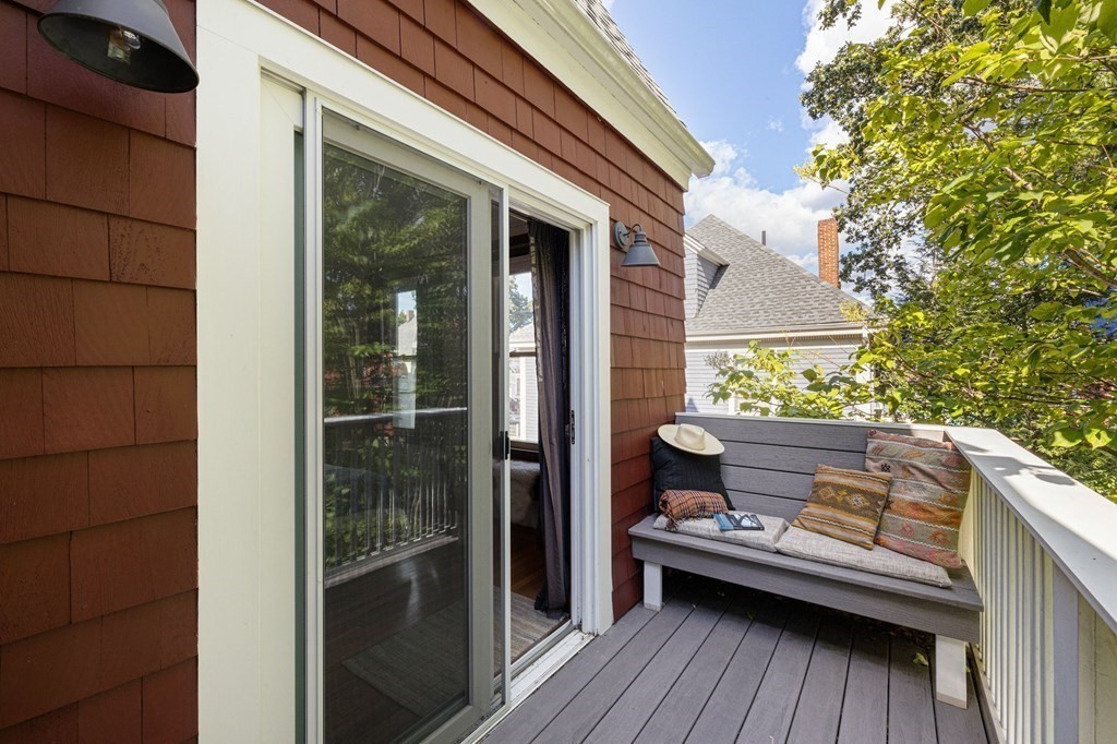 18 Alpha Road Boston, MA 02124 - Photo 26 of 42 a view of a balcony with chairs and wooden floor