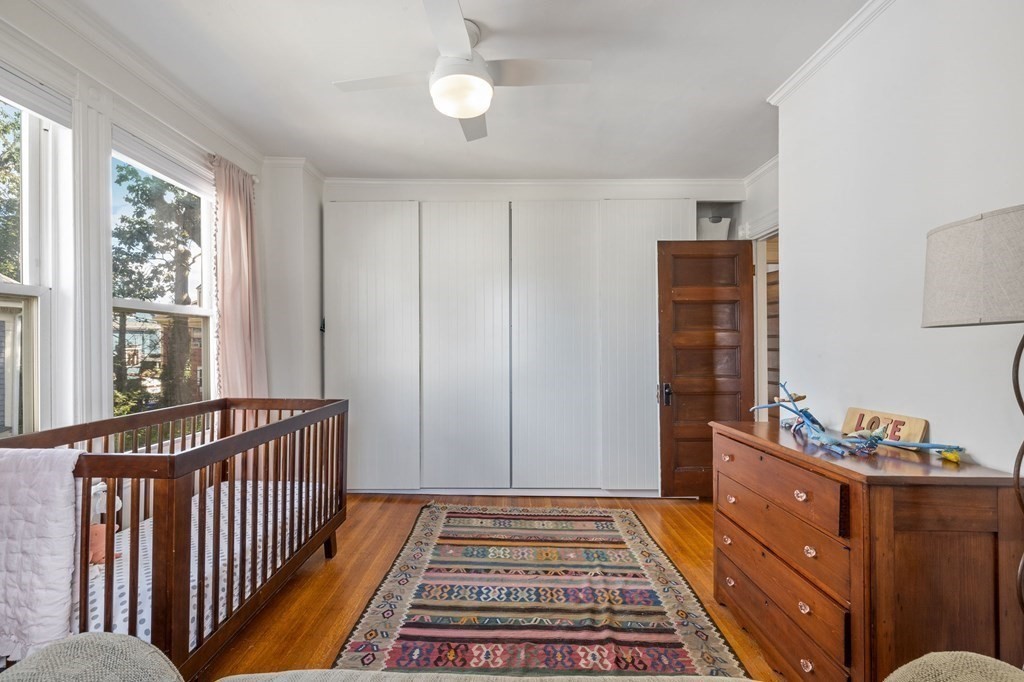 18 Alpha Road Boston, MA 02124 - Photo 29 of 42 a bedroom with a bed and wooden floor