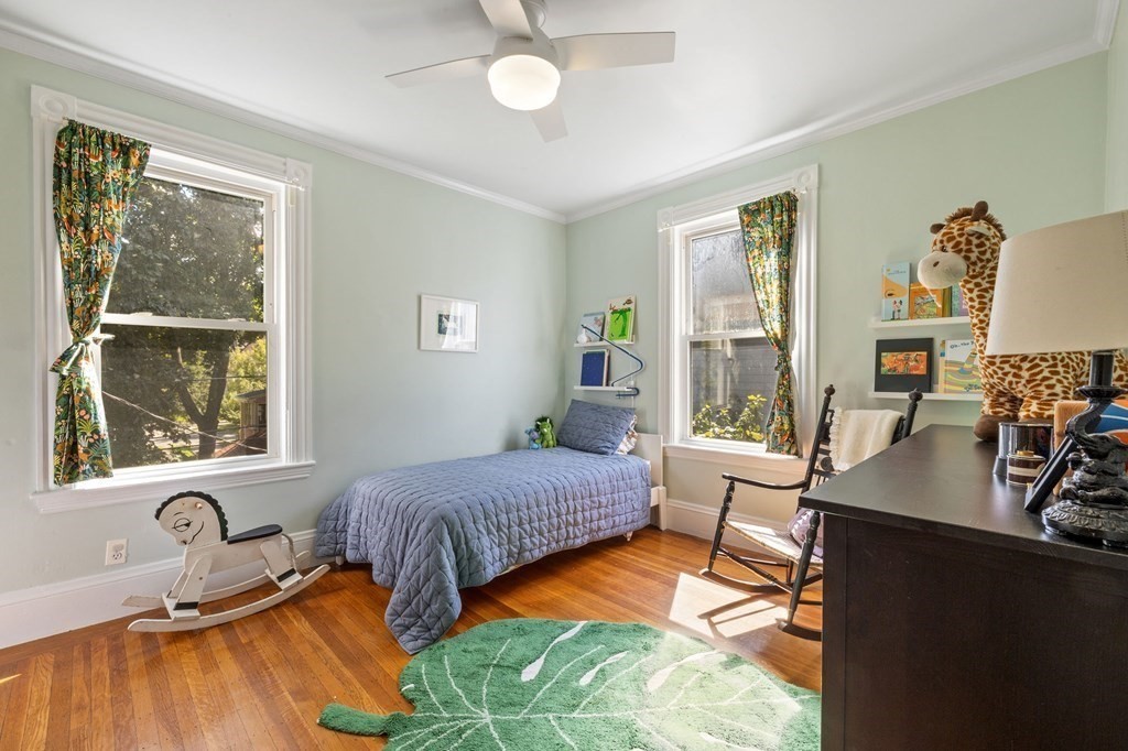 18 Alpha Road Boston, MA 02124 - Photo 31 of 42 a bedroom with a bed and wooden floor