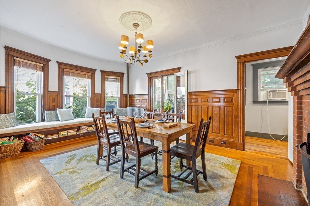 18 Alpha Road Boston, MA 02124 - Photo 7 of 42 a view of a dining room with furniture wooden floor and chandelier