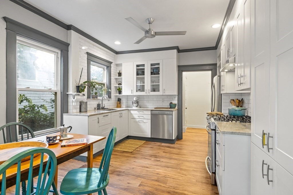 18 Alpha Road Boston, MA 02124 - Photo 10 of 42 a kitchen with a table chairs stove and cabinets