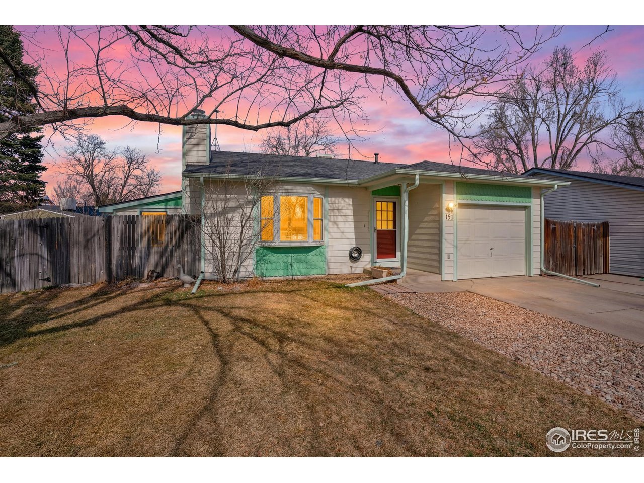 a view of a house with a yard and garage