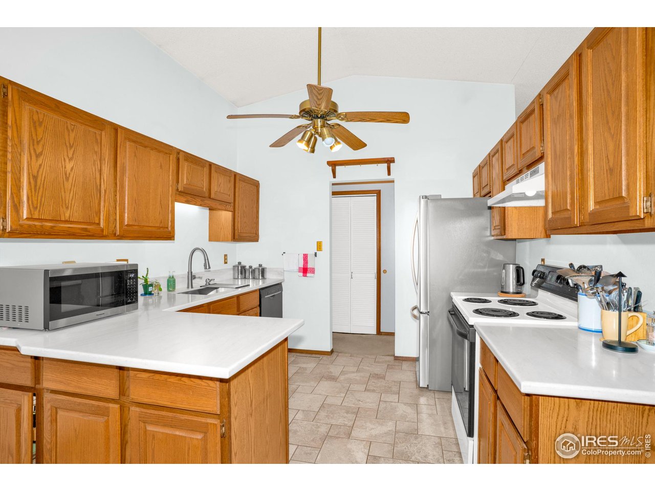 151 3rd Street Frederick, CO 80530 - Photo 11 of 45 a kitchen with stainless steel appliances granite countertop a sink stove and refrigerator