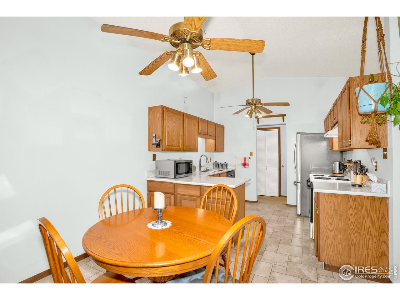151 3rd Street Frederick, CO 80530 - Photo 13 of 45 a living room with furniture a chandelier and a dining table