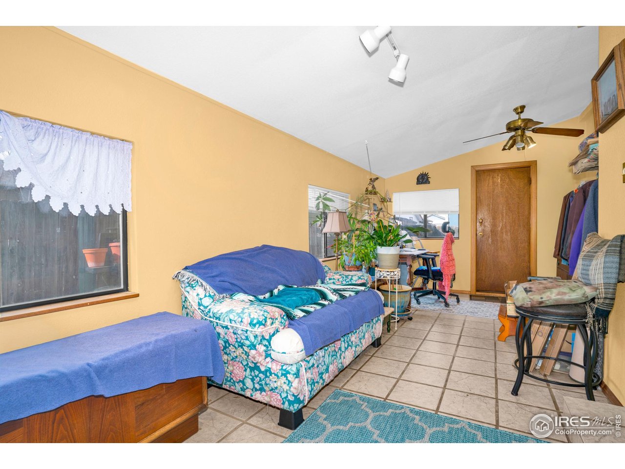 151 3rd Street Frederick, CO 80530 - Photo 14 of 45 a living room with furniture and a painting on the wall