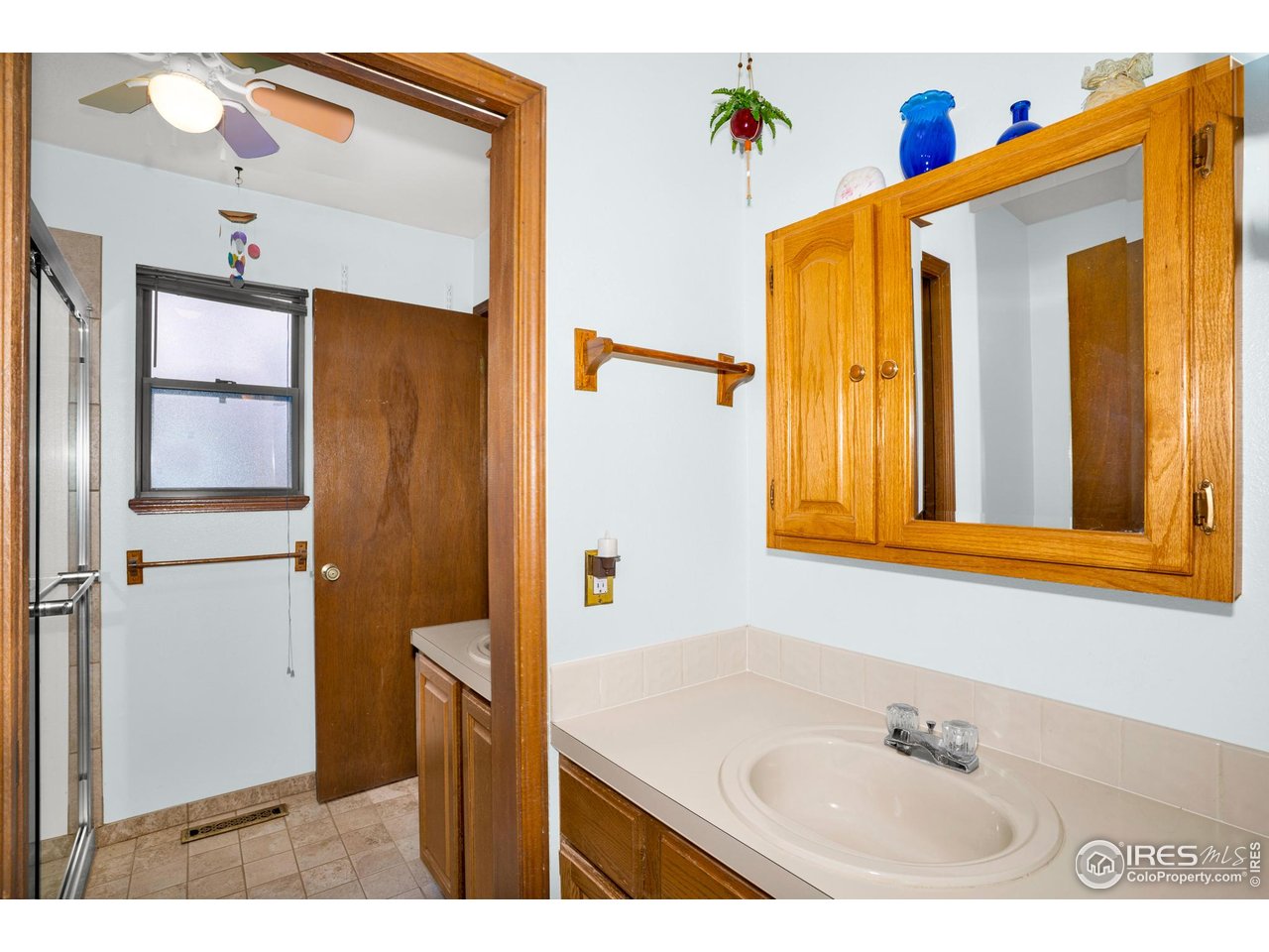 151 3rd Street Frederick, CO 80530 - Photo 17 of 45 a bathroom with a sink a mirror and a shower