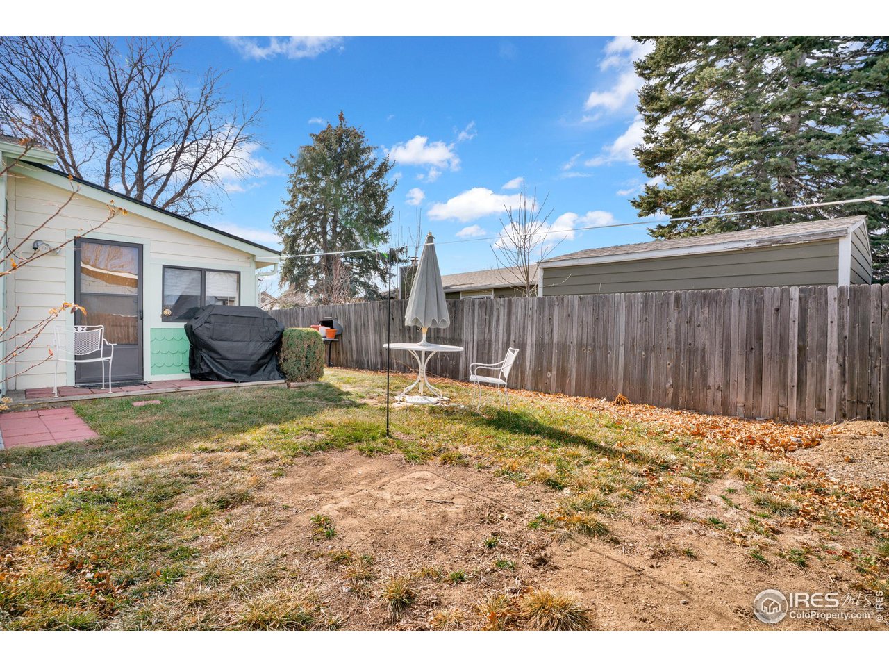 151 3rd Street Frederick, CO 80530 - Photo 22 of 45 a backyard of a house with table and chairs