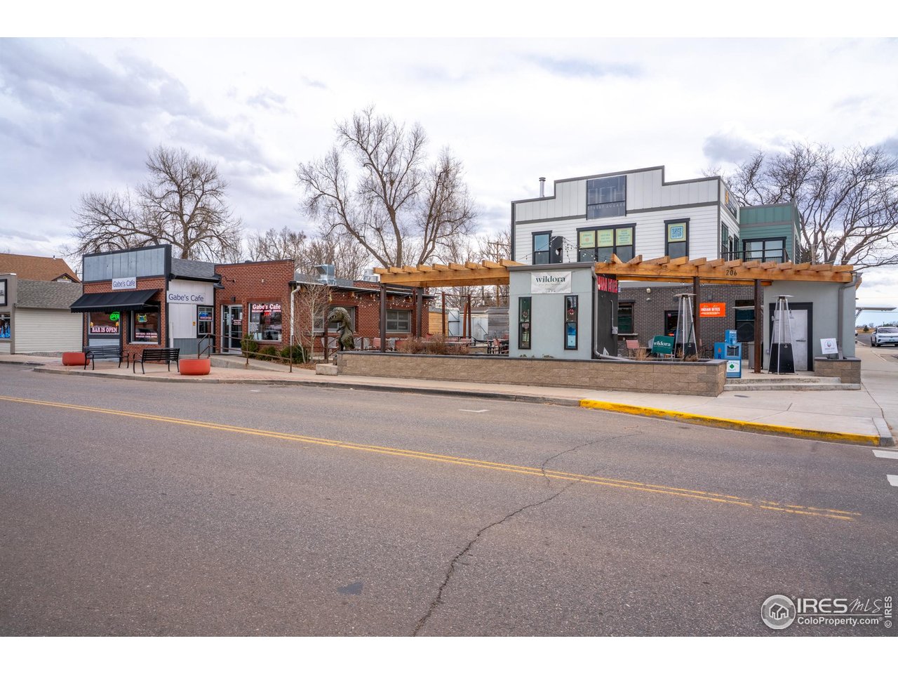 151 3rd Street Frederick, CO 80530 - Photo 41 of 45 a front view of a building with large trees