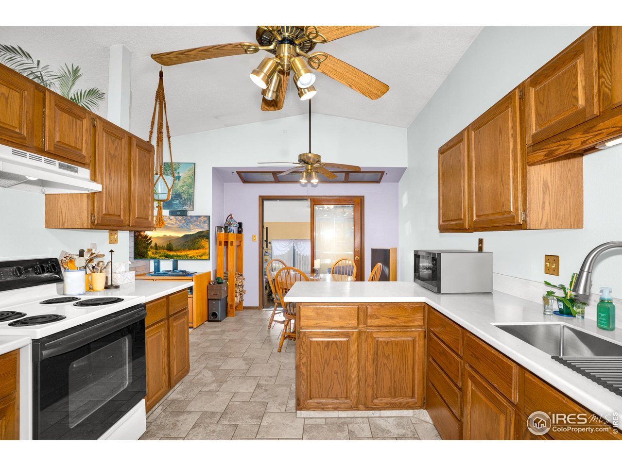 151 3rd Street Frederick, CO 80530 - Photo 10 of 45 a kitchen with a sink a stove and cabinets