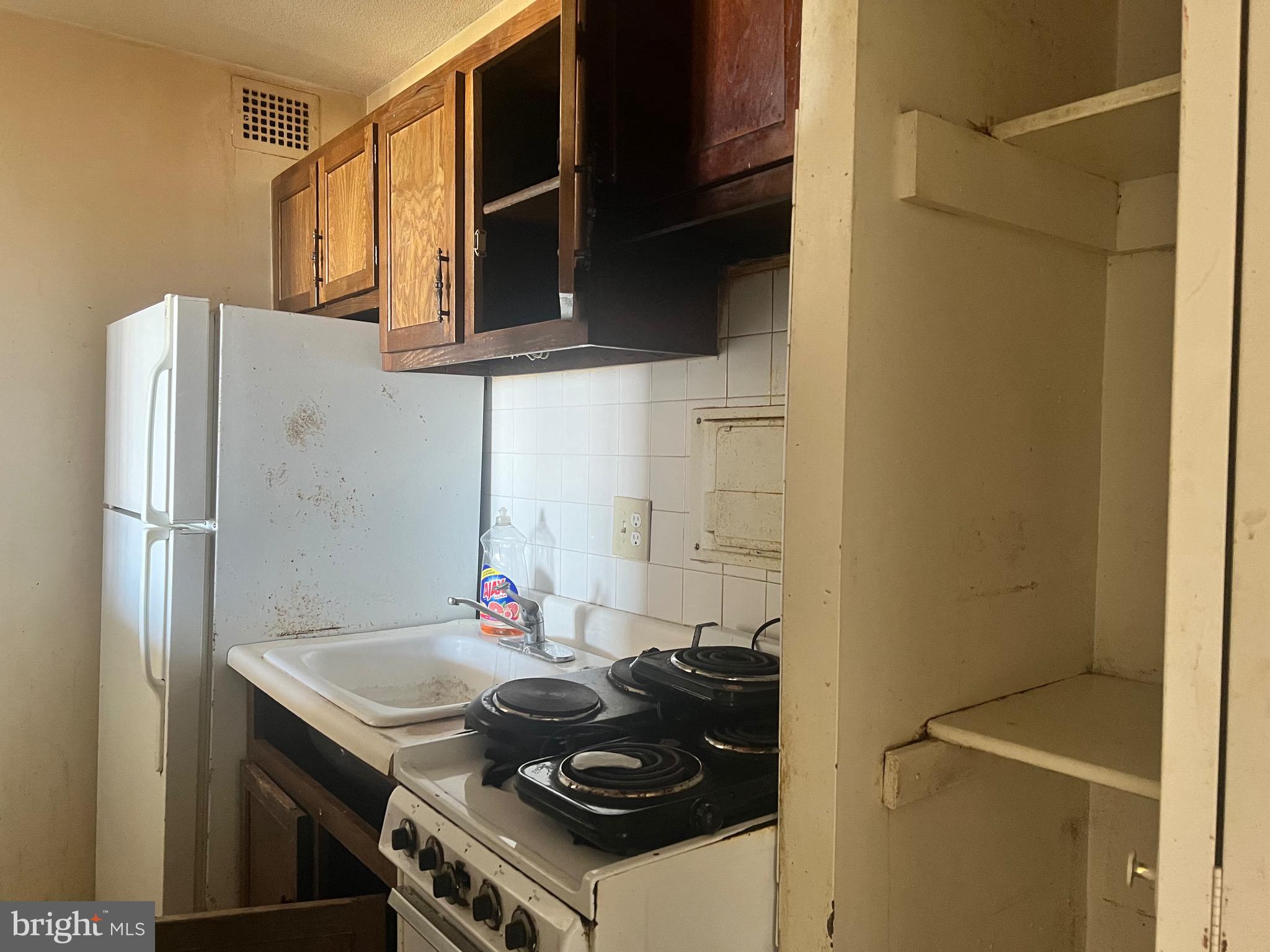 1836 Metzerott Road, Unit 1717 Hyattsville, MD 20783 - Photo 5 of 12 a kitchen with stainless steel appliances granite countertop a sink stove and refrigerator