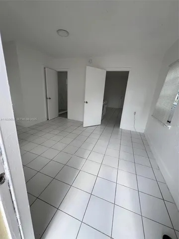 a view of a livingroom with an empty space and a fireplace