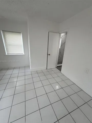 a view of an empty room and utility room