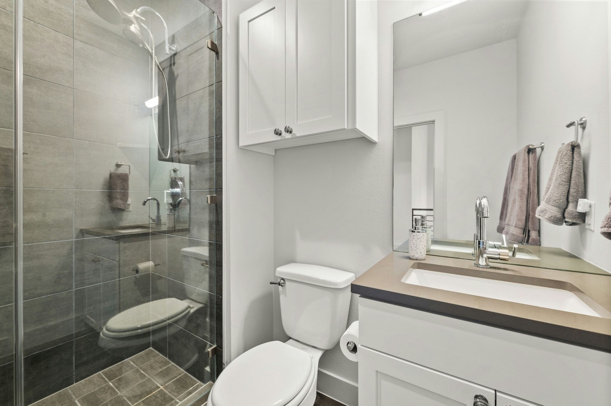 8110 Ranch Road 2222, Unit 92 Austin, TX 78730 - Photo 24 of 40 Shower enclosure with clear glass paneling and stone-look tile