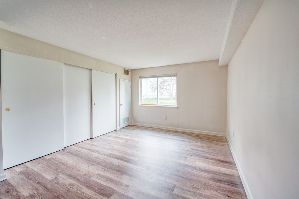 3 Post Oak Lane, Unit 4 Natick, MA 01760 - Photo 15 of 34 an empty room with wooden floor and windows