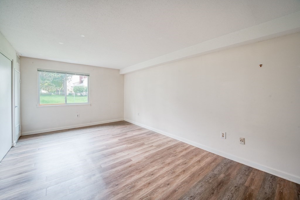 3 Post Oak Lane, Unit 4 Natick, MA 01760 - Photo 16 of 34 an empty room with wooden floor and windows