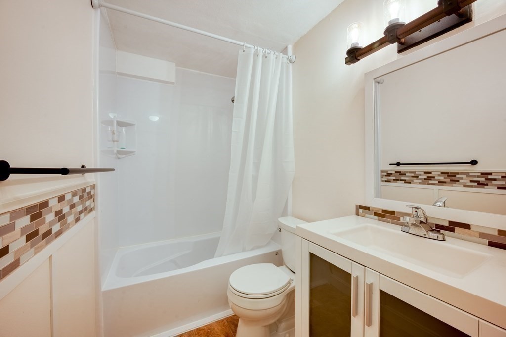 3 Post Oak Lane, Unit 4 Natick, MA 01760 - Photo 17 of 34 a bathroom with a sink a toilet and shower