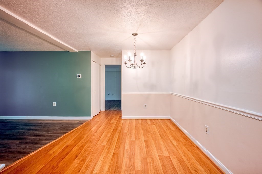 3 Post Oak Lane, Unit 4 Natick, MA 01760 - Photo 7 of 34 a view of a room with wooden floor and chandelier