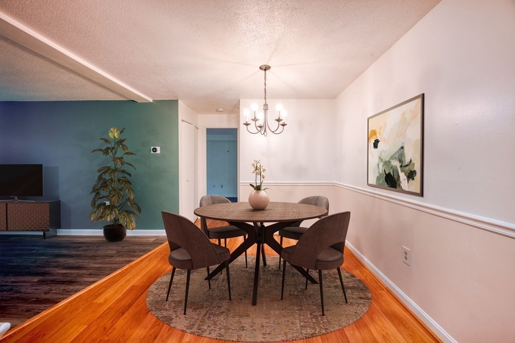 3 Post Oak Lane, Unit 4 Natick, MA 01760 - Photo 8 of 34 a dining room with furniture potted plants and wooden floor