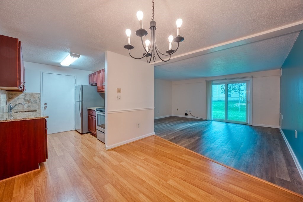 3 Post Oak Lane, Unit 4 Natick, MA 01760 - Photo 9 of 34 a view of a room with wooden floor and chandelier
