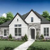 a view of a white house next to a yard