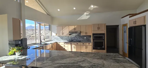 a kitchen with a refrigerator and window