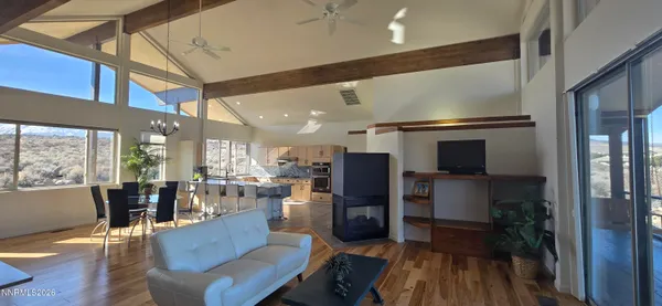 a large living room with granite countertop kitchen island granite countertop furniture a rug and a window