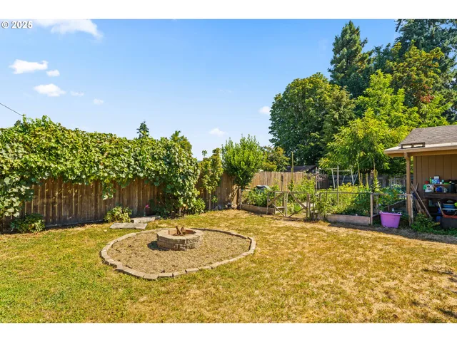 a backyard of a house with table and chairs