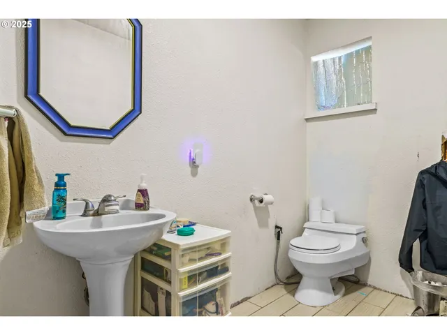 a bathroom with a sink toilet and a mirror