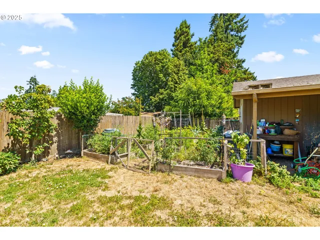 a backyard of a house with table and chairs