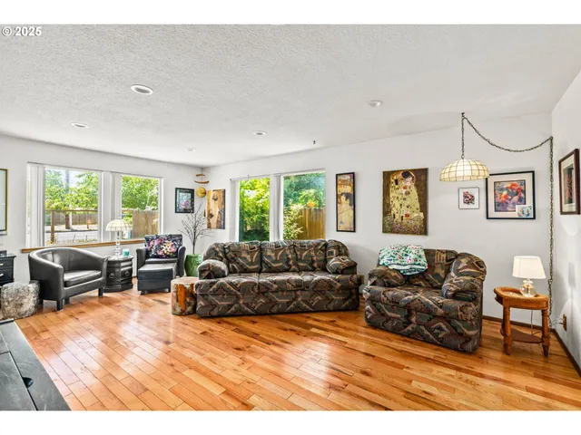a living room with furniture window and wooden floor