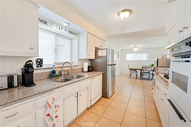 a kitchen with stainless steel appliances granite countertop a sink and cabinets