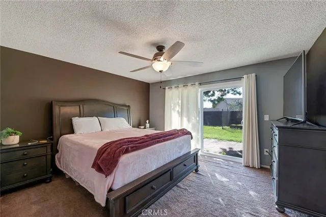 a spacious bedroom with a bed and a large window