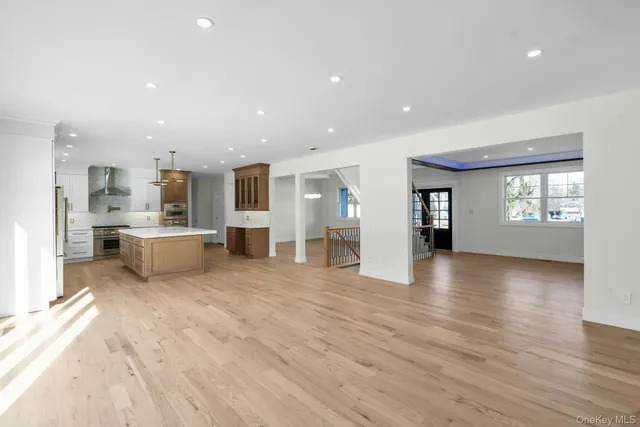 a view of a kitchen with a sink dishwasher and a living room
