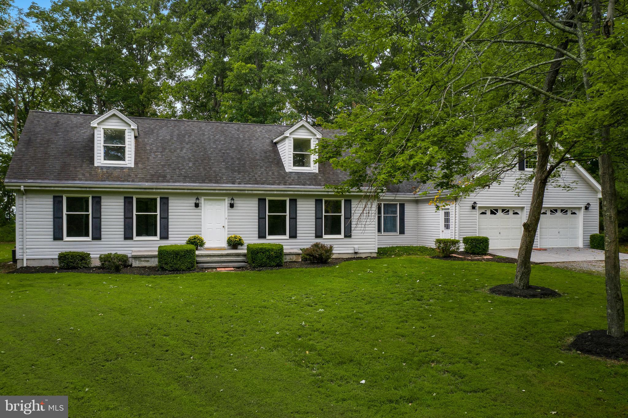 1504 New Hope Road Cross Junction, VA 22625 - Photo 2 of 35 a front view of a house with a garden and trees