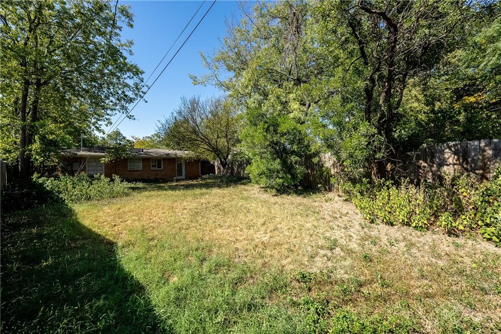 3705 Tower View Court Austin, TX 78723 - Photo 14 of 15 a yellow house with trees in the background