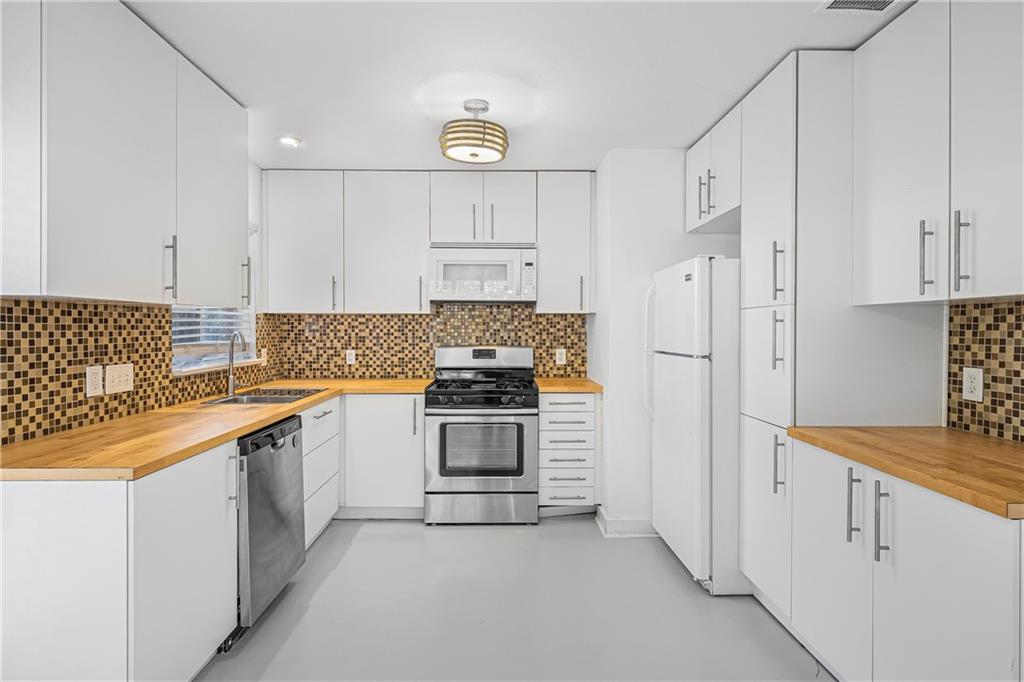 3705 Tower View Court Austin, TX 78723 - Photo 2 of 15 a kitchen with stainless steel appliances granite countertop a stove and a refrigerator
