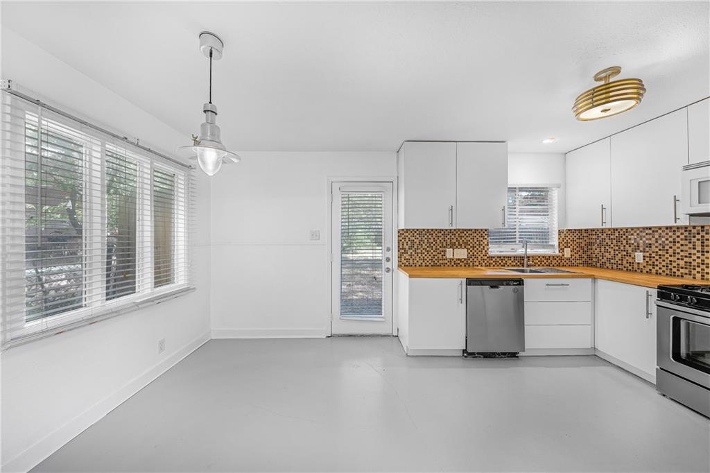 3705 Tower View Court Austin, TX 78723 - Photo 3 of 15 a kitchen with a refrigerator and a stove