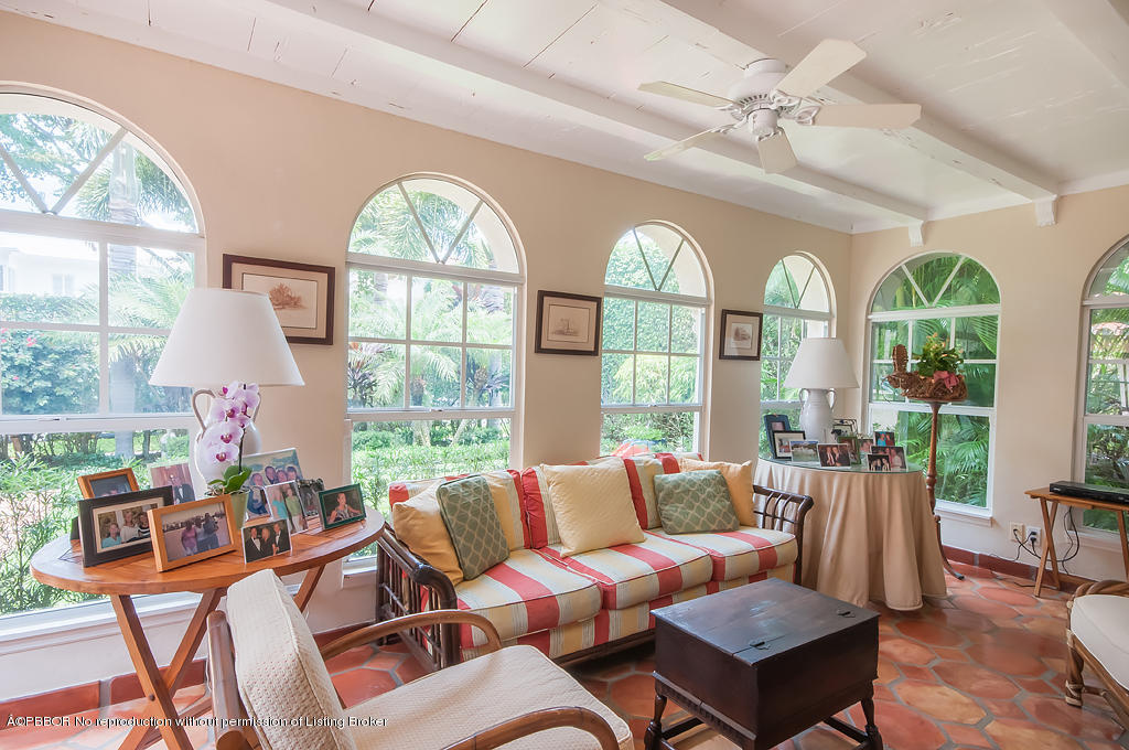 282 Barcelona Road West Palm Beach, FL 33401 - Photo 11 of 32 a living room with furniture a chandelier and a large window