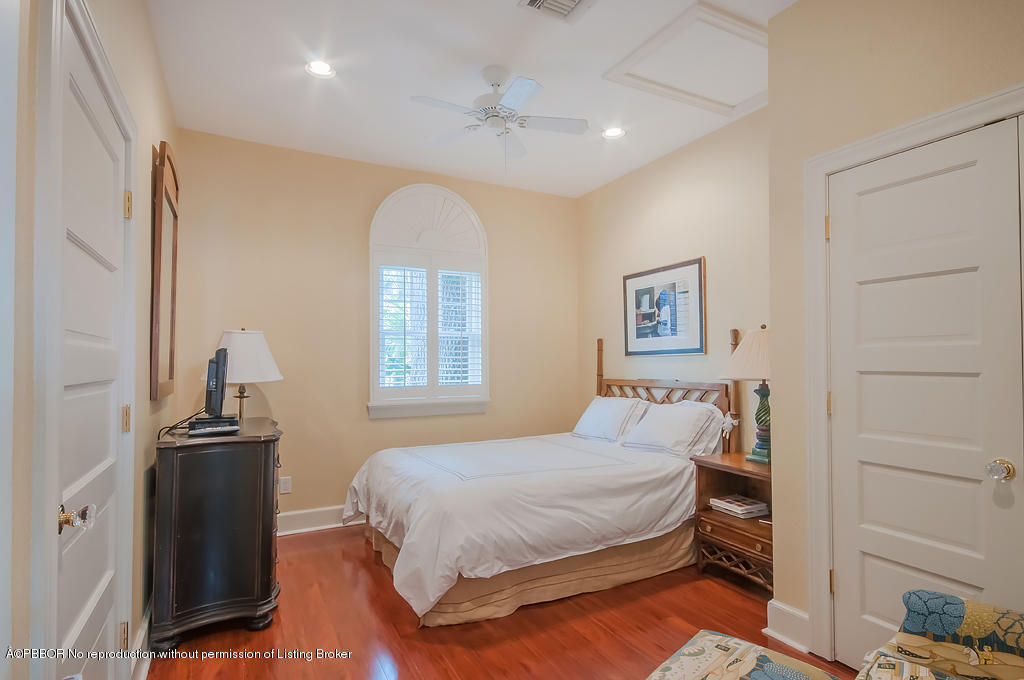 282 Barcelona Road West Palm Beach, FL 33401 - Photo 13 of 32 a bedroom with a bed and a chandelier